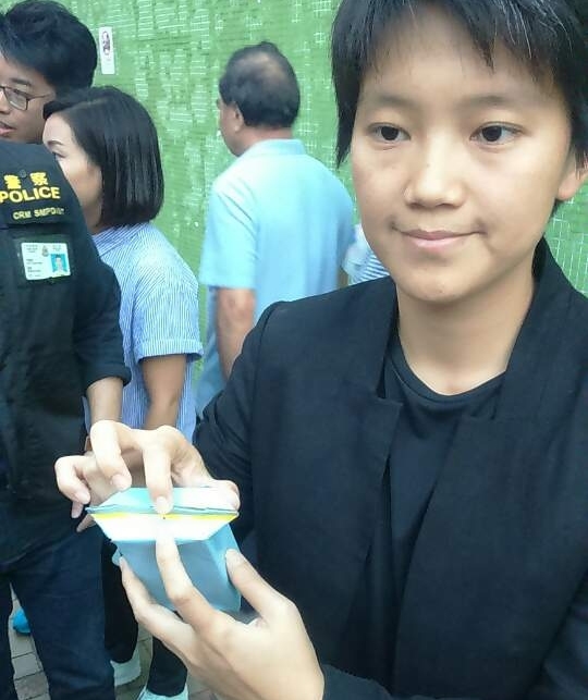 秀茂坪警區刑事總督察鄢曉宇以同類紙包飲品，展示針孔位置。(曾秋文攝)