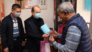 張建宗（中）到訪北角健康村，向長者及住戶派發口罩等防疫物資。（政府新聞處）