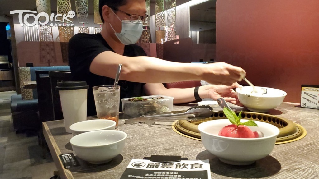 黃傑龍在計劃實施前，正嘗試客人自行包裝外賣會否做成不便。（陳梓蔚攝）