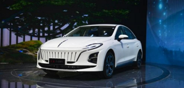 A white Hongqi E-QM5 electric taxi is displayed on stage, emphasizing its innovative rapid battery swapping technology showcased in Hong Kong.